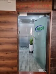 Entrance to the Adroit Infosol office, with the company logo on the glass door